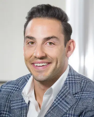 Dr. Tasos Belegratis, the course mentor: a portrait in a checked jacket and an open-necked white shirt